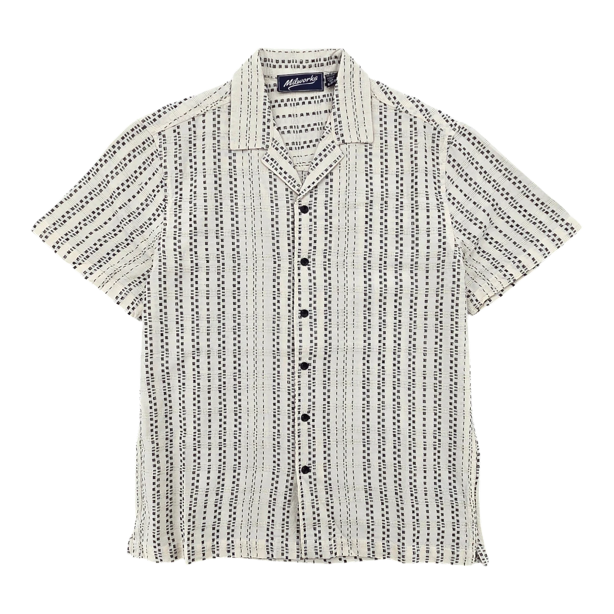 MILWORKS cream woven camp shirt with a vertical dashed line pattern and black buttons. Short sleeves and open collar.