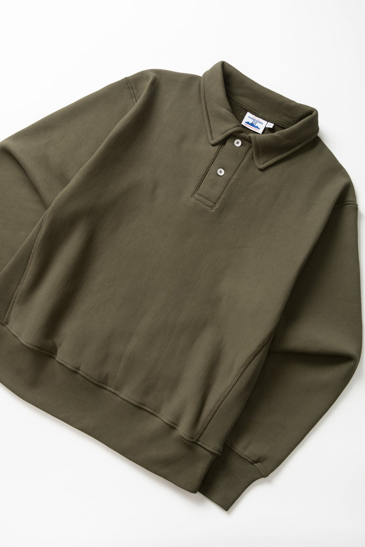 MILWORKS dark olive heavyweight organic cotton rugby shirt with a two-button collar and ribbed cuffs.