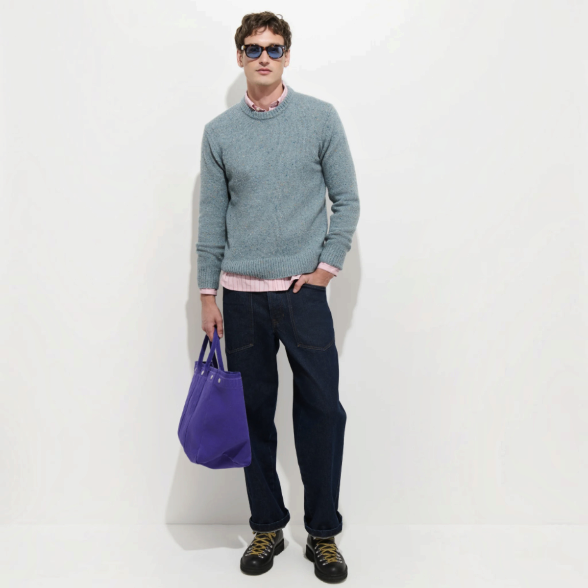 MILWORKS Donegal crew neck sweater in sea mist wool-alpaca blend worn by a model with dark jeans and a purple bag