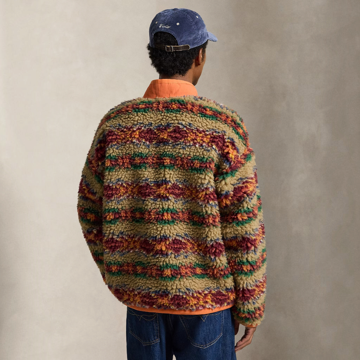 Back view of a model wearing a MILWORKS relaxed fit high-pile fleece pullover with a red rock Fair Isle print.