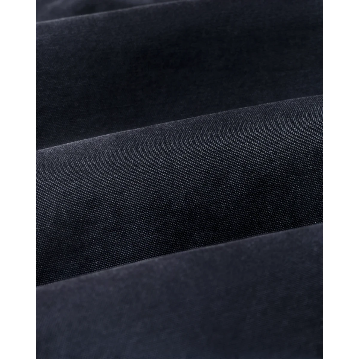 Close-up of the durable dark navy canvas fabric texture on a MILWORKS Filson Insulated Canvas Outfitter Jacket