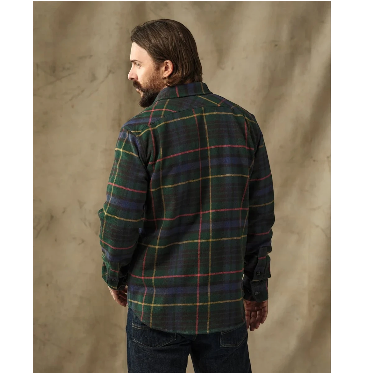 MILWORKS Filson vintage green and navy plaid flannel work shirt with back shoulder pleats on a bearded model