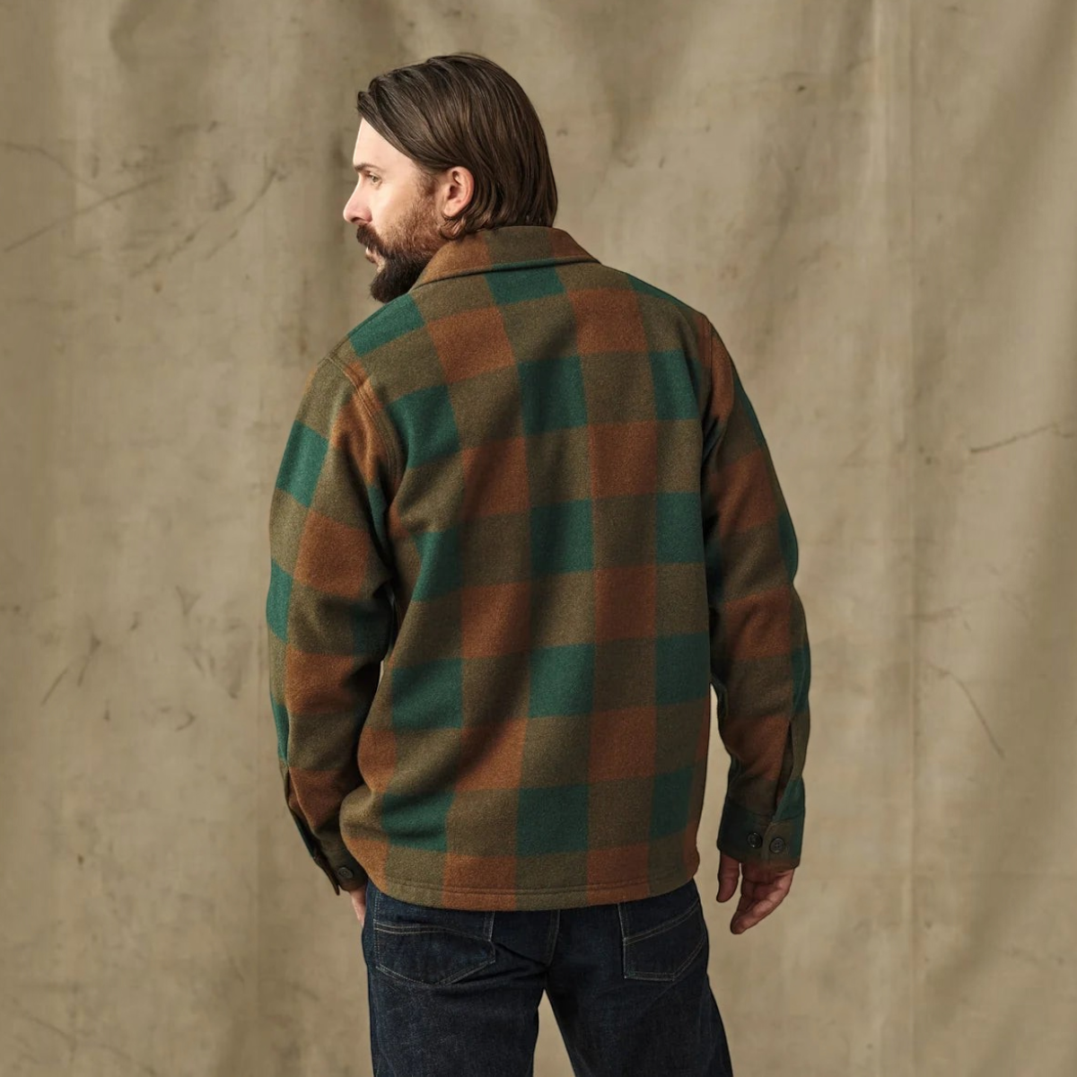 MILWORKS Filson wool jac-shirt in bronze green plaid, featuring a relaxed fit and straight hem, worn from the back.