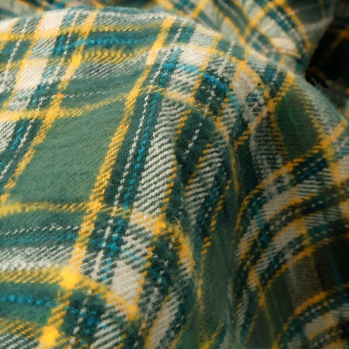 MILWORKS green slub heavy flannel shirt fabric with a textured brushed finish and a small muted check pattern.