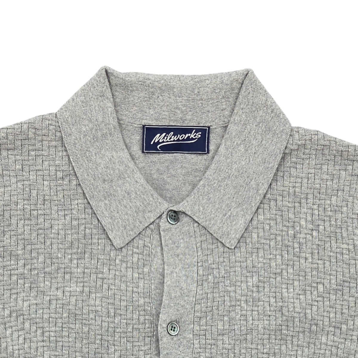 MILWORKS grey short sleeve knit shirt with a basketweave texture, collared neckline, and button placket. Made from cotton and cashmere blend.