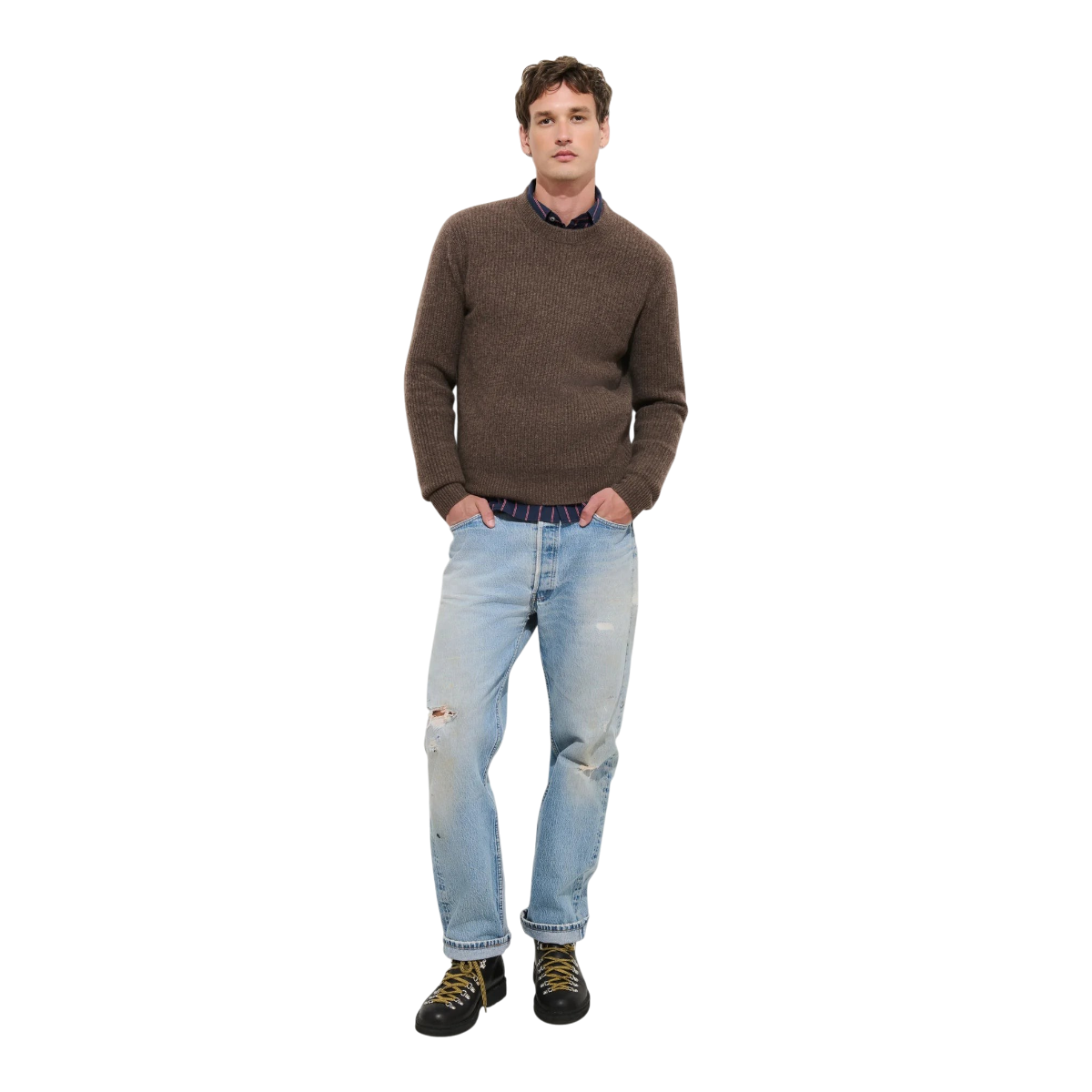 MILWORKS model wearing a brown washed cashmere crewneck sweater with light wash distressed jeans and hiking boots