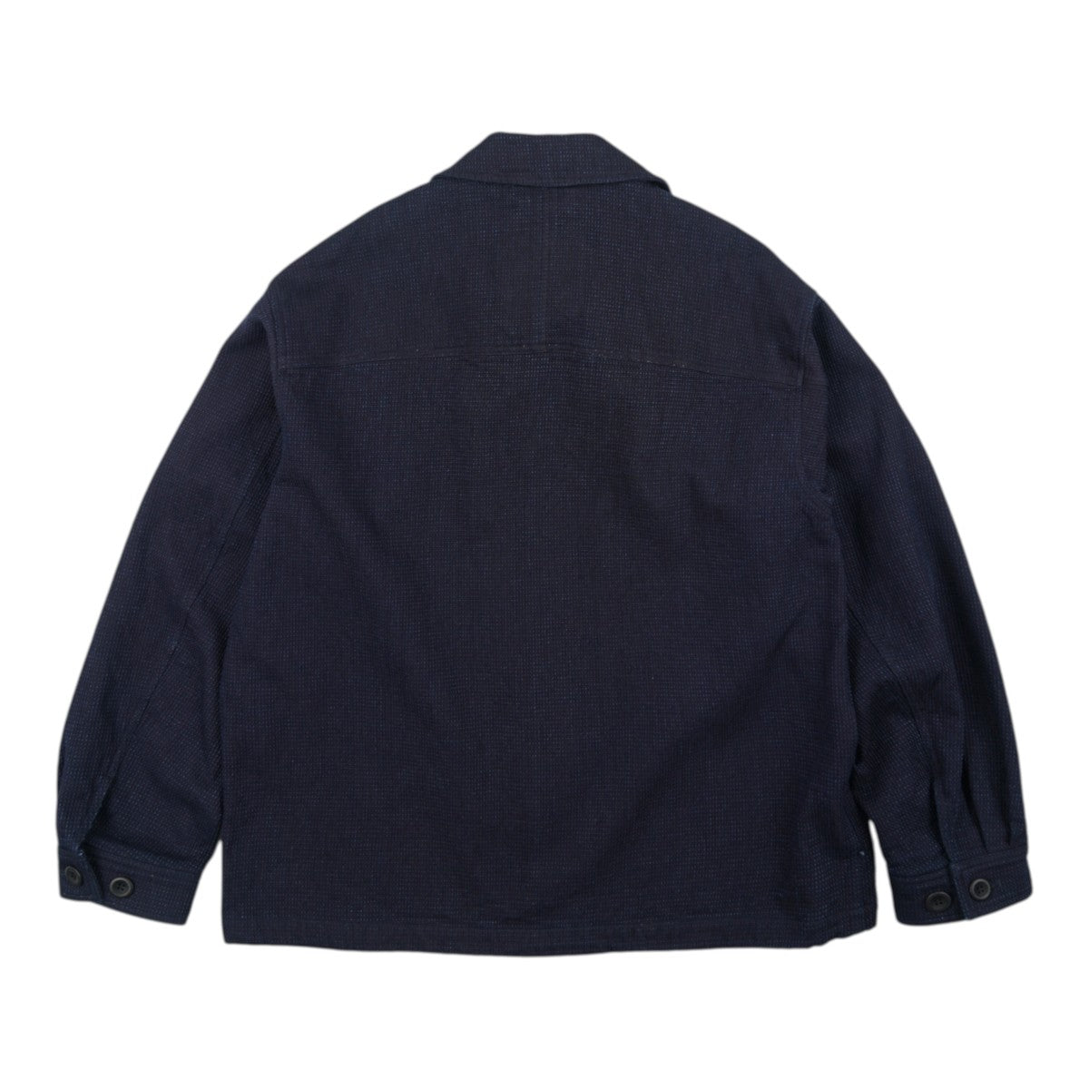 Back view of a MILWORKS indigo sashiko coverall jacket with textured stitching and a relaxed fit.