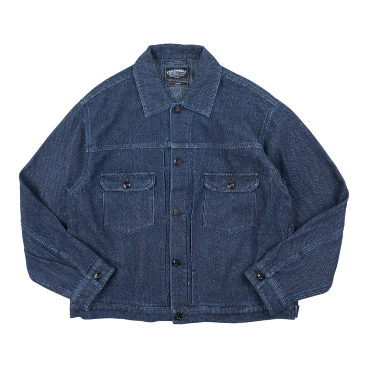 MILWORKS indigo sashiko trucker jacket with button-down front, dual chest pockets, and detailed stitching.