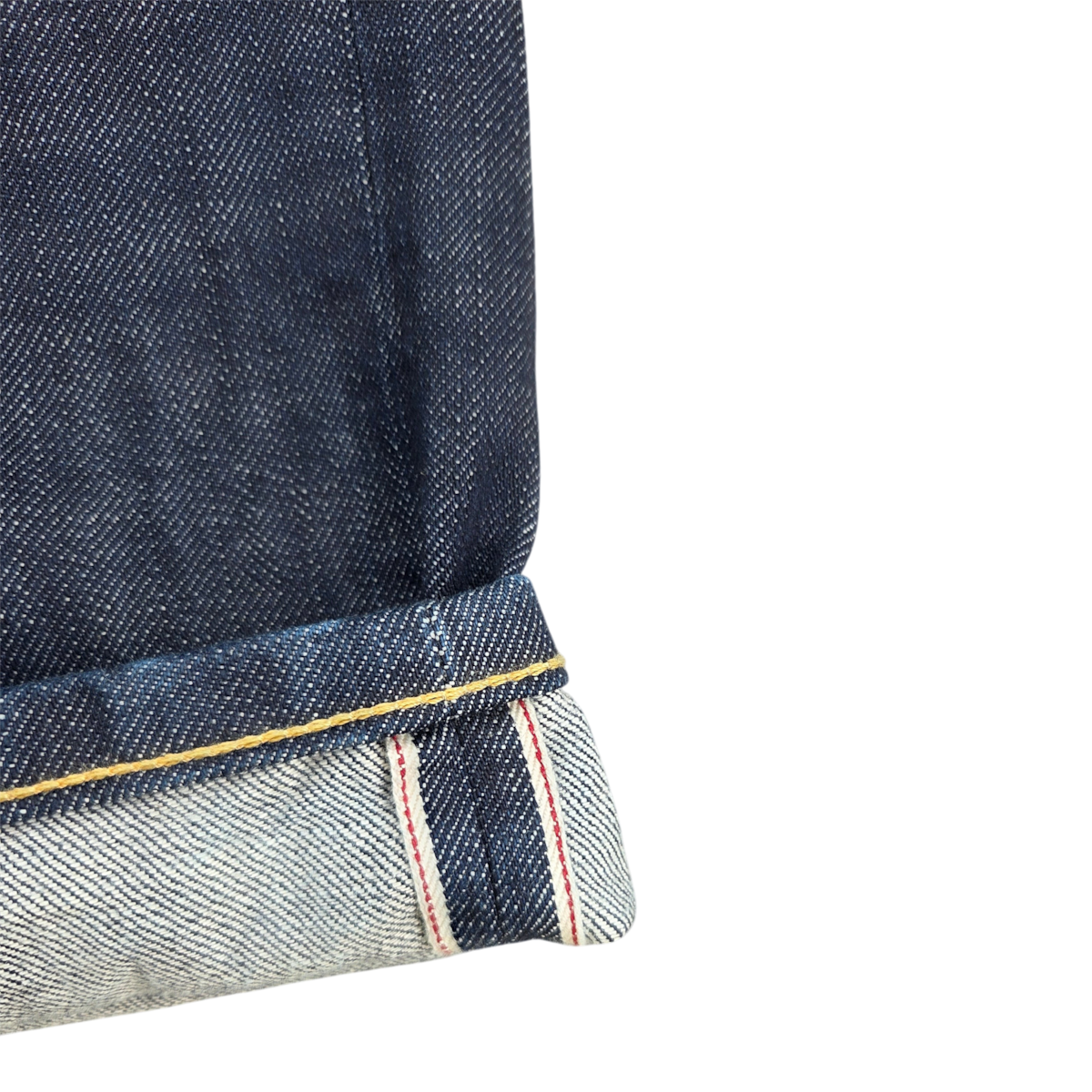 MILWORKS COF Studio M9 relaxed indigo selvedge denim jeans with a cuffed hem showing red line selvedge detail