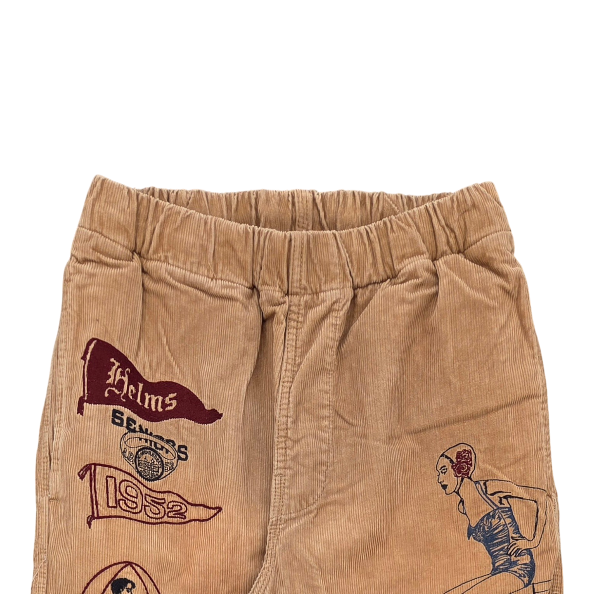 MILWORKS khaki corduroy pants featuring vintage-style multicolor embroidery of pennants and a pin-up girl illustration