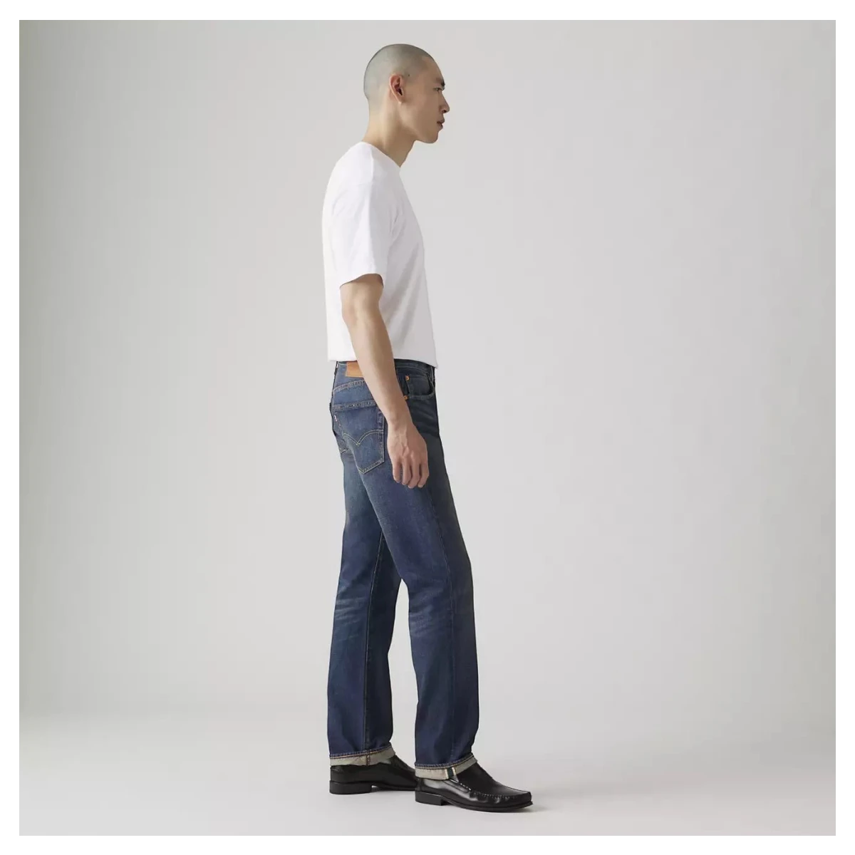 MILWORKS model wearing Levi's 501 Original selvedge jeans in dark wash Bounty Hunter denim with a straight leg fit