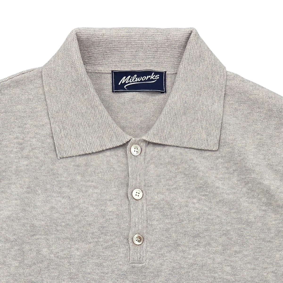 MILWORKS light grey short sleeve knit polo shirt with a spread collar and three button placket. Made from 95% cotton and 5% cashmere.