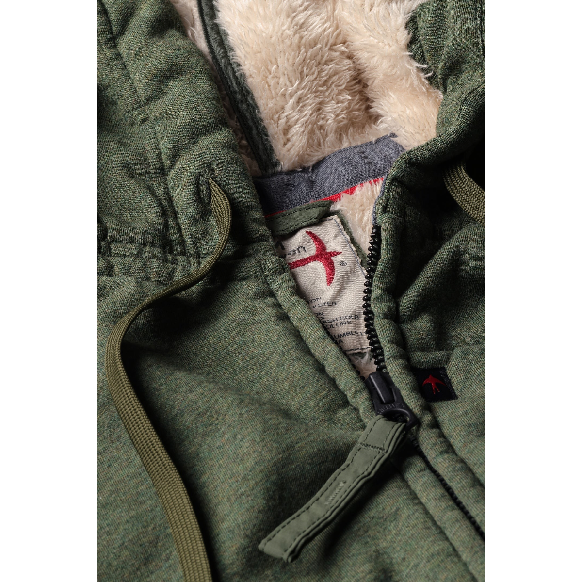 Milworks loden heather superfleece hoodie with cotton jersey face, sherpa lining, and brass two-way front zipper.