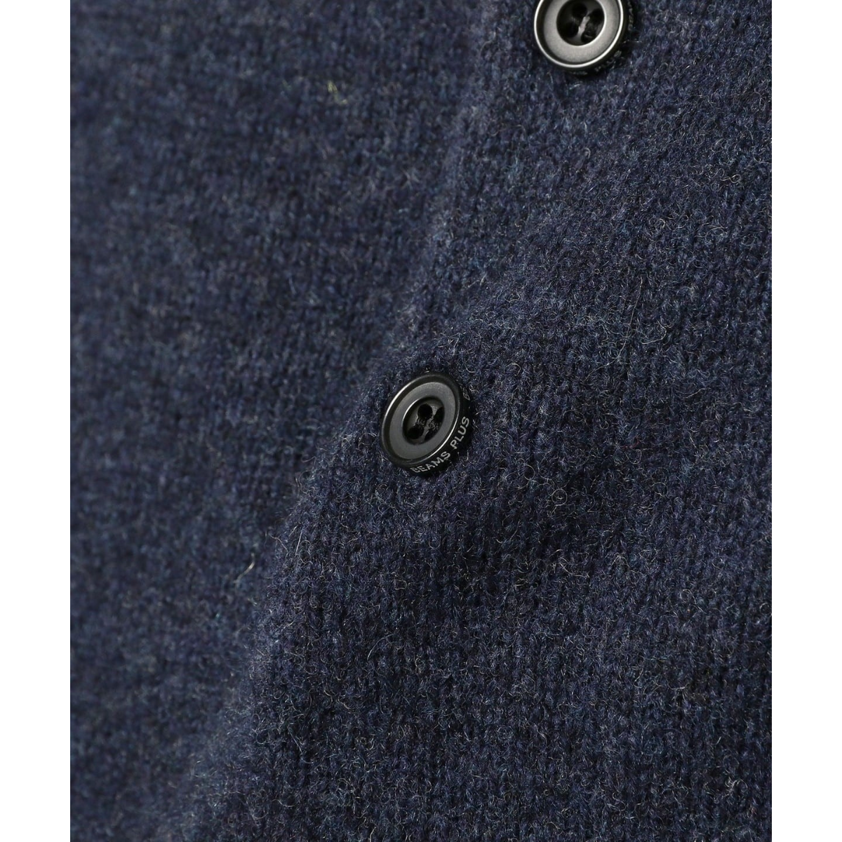 Close-up of a MILWORKS navy 9-gauge wool knit polo shirt featuring dark buttons with BEAMS PLUS branding