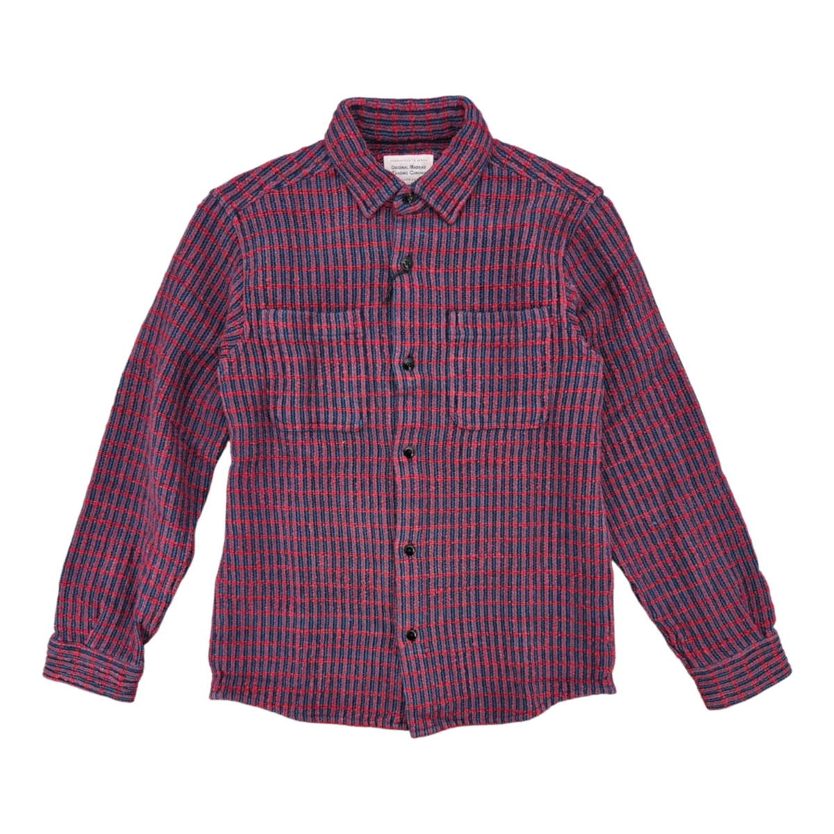 MILWORKS No111 overshirt in a red and blue handwoven cotton check pattern with a rounded hem and button-up front.