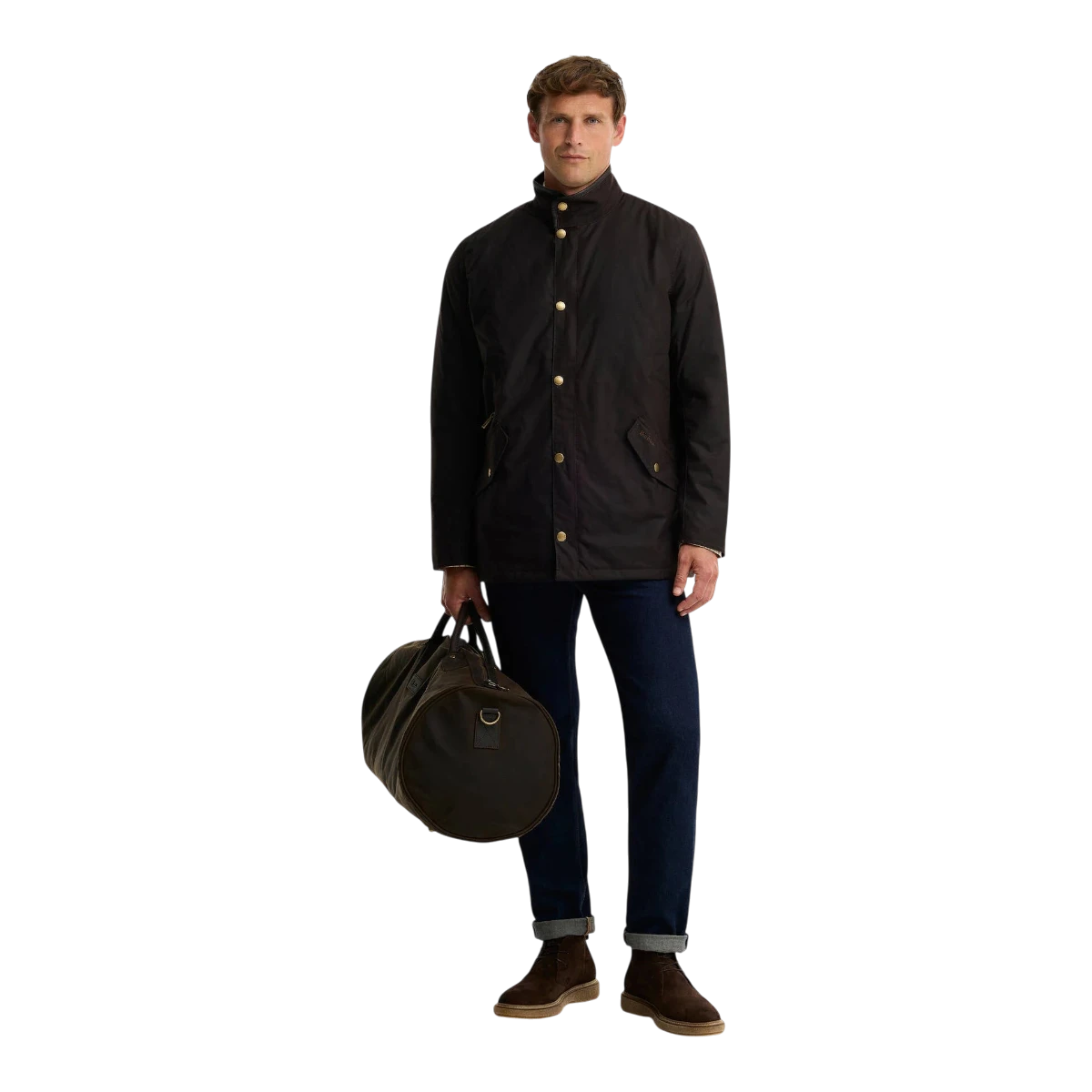 MILWORKS model wearing a dark olive waxed jacket and holding a matching olive waxed cotton holdall bag.