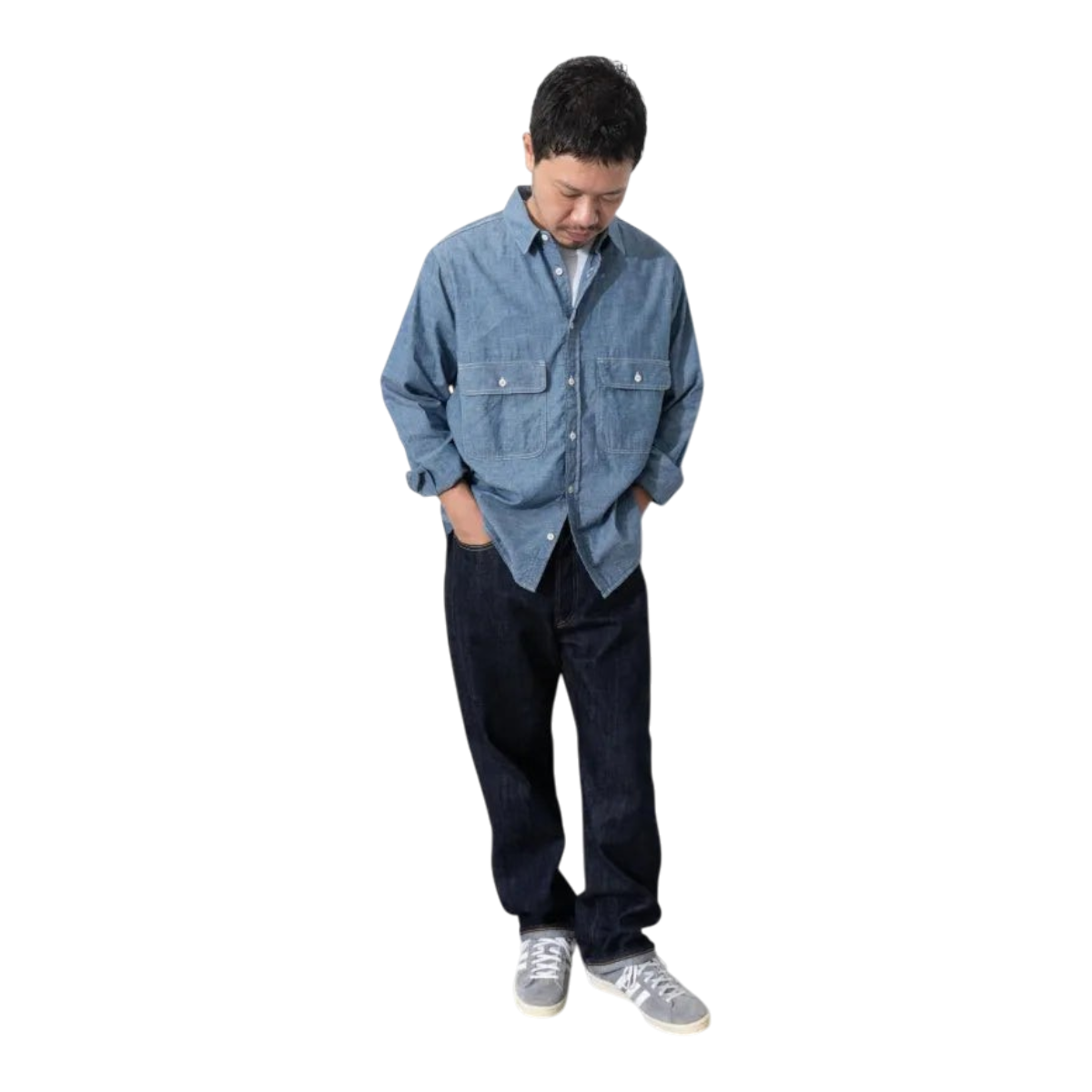 MILWORKS model wearing an Ordinary Fits indigo chambray work shirt with oversized pockets and a boxy fit.
