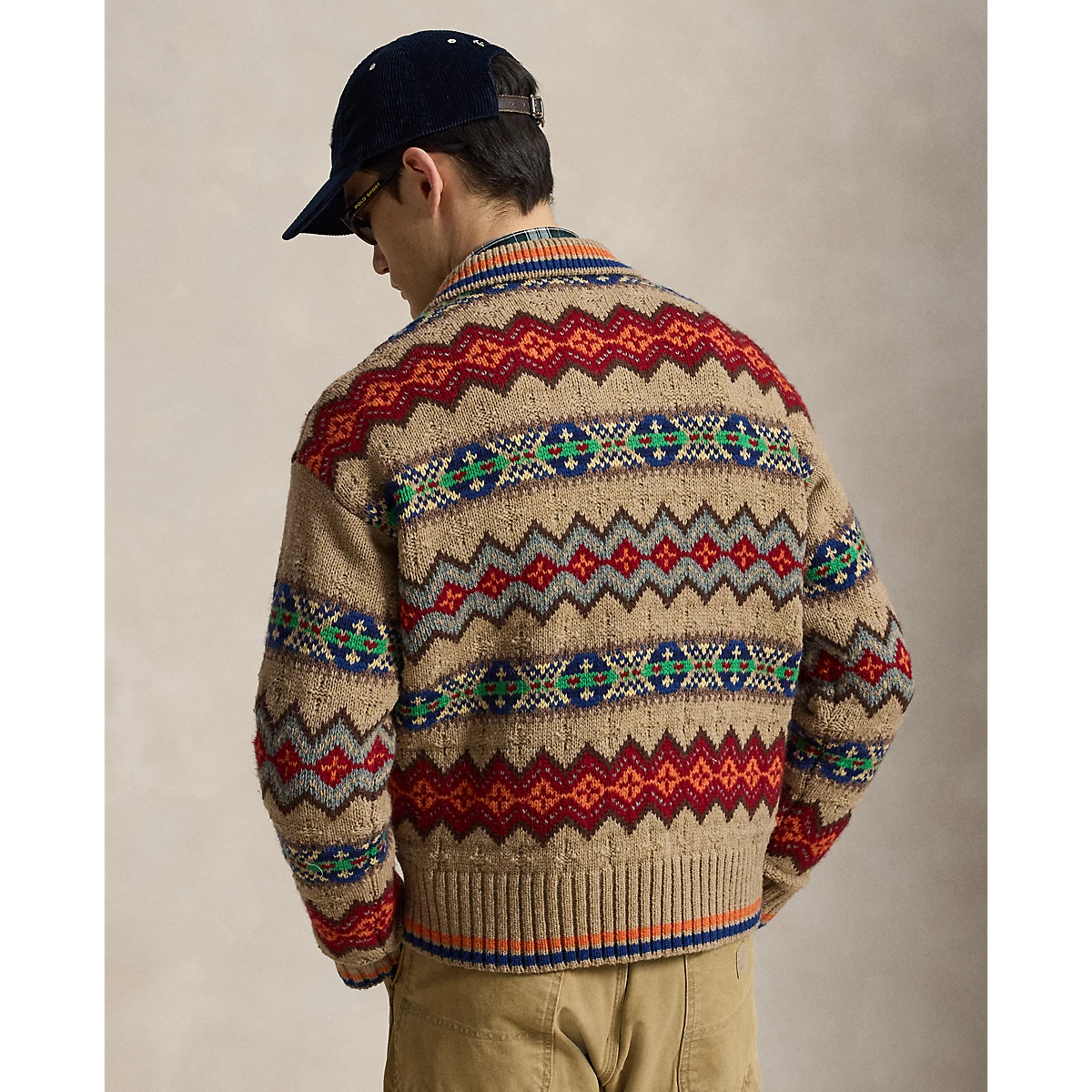 MILWORKS Polo Ralph Lauren tan Fair Isle sweater polo with vibrant geometric patterns worn by a man in a cap