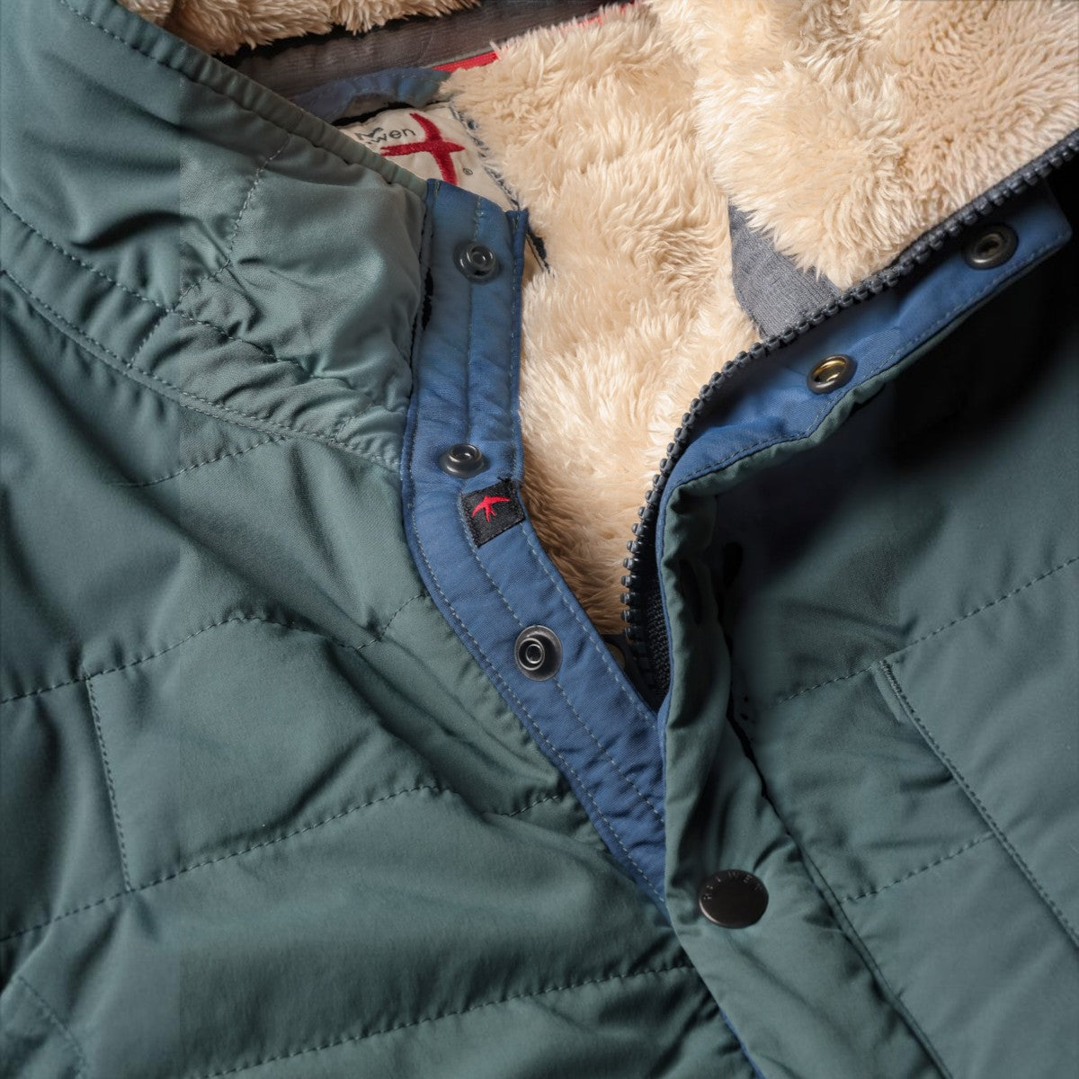 MILWORKS Quilted Superfleece Popover in spruce green with a soft beige faux fur lining and snap button placket
