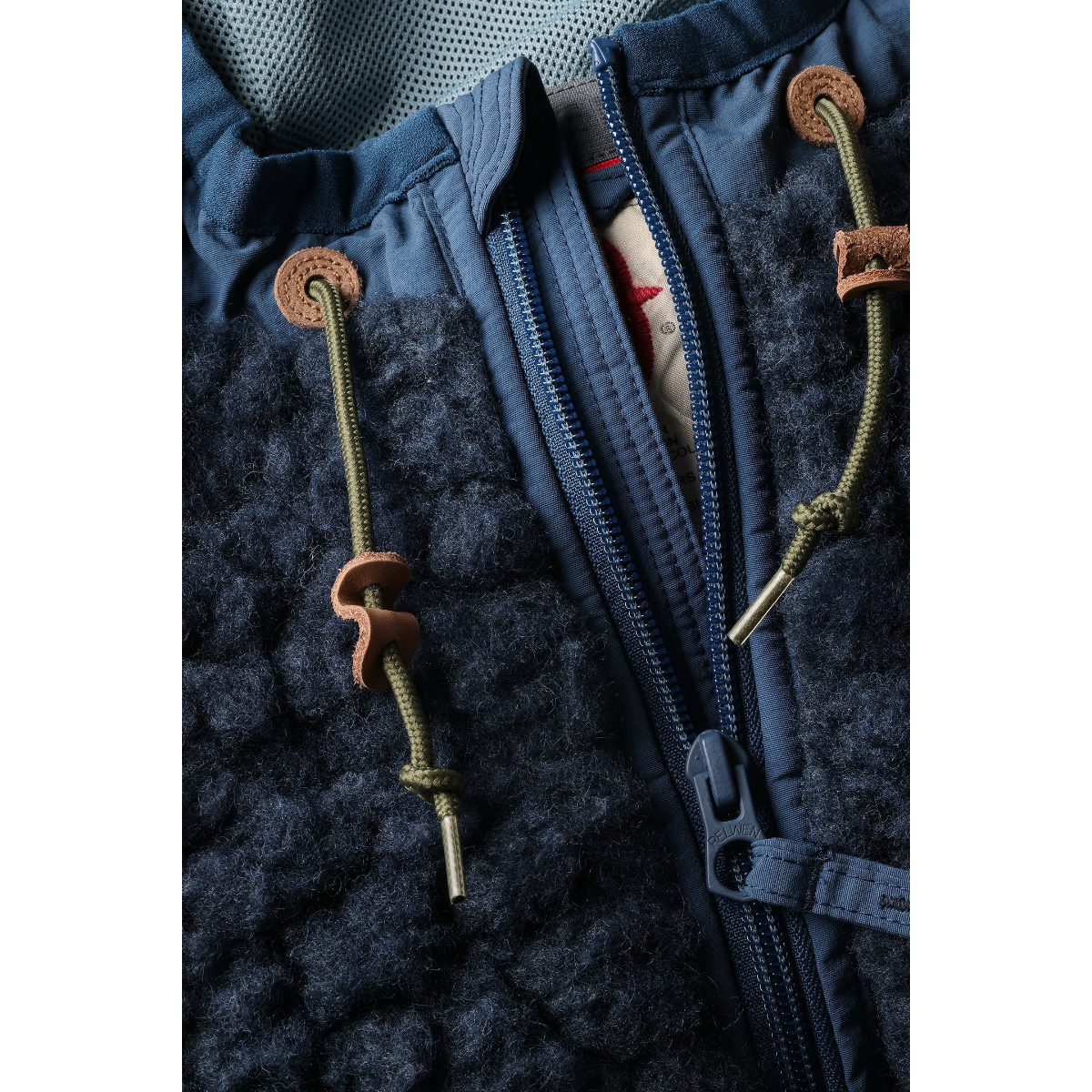 Milworks Relwen Abominable Hood in navy heather wool sherpa pile with leather drawcord details and front zipper.