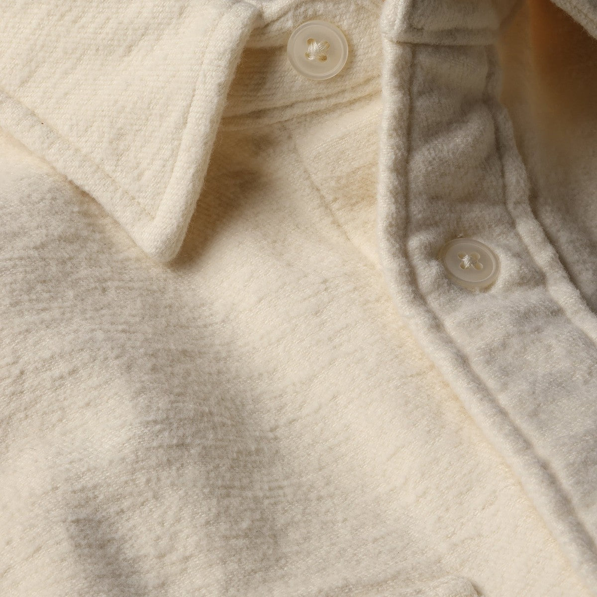 MILWORKS Relwen Utility Workshirt in bone felted twill with a button-down collar and red interior neck trim.