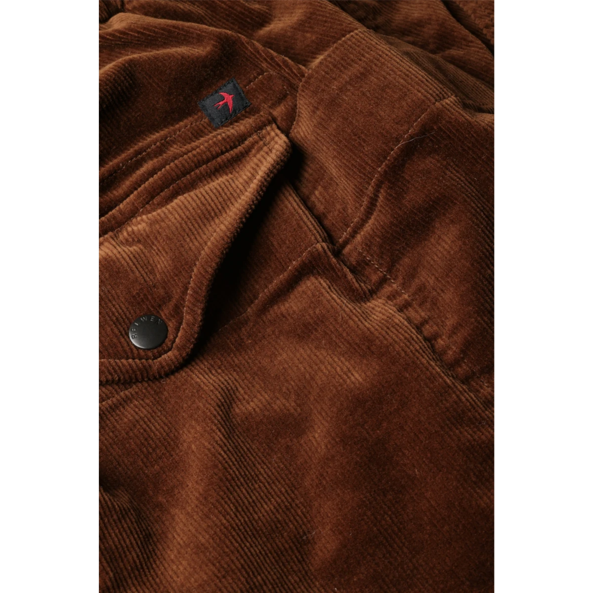 MILWORKS Relwen chestnut brown corduroy utility pants featuring a buttoned flap pocket and branded hardware.