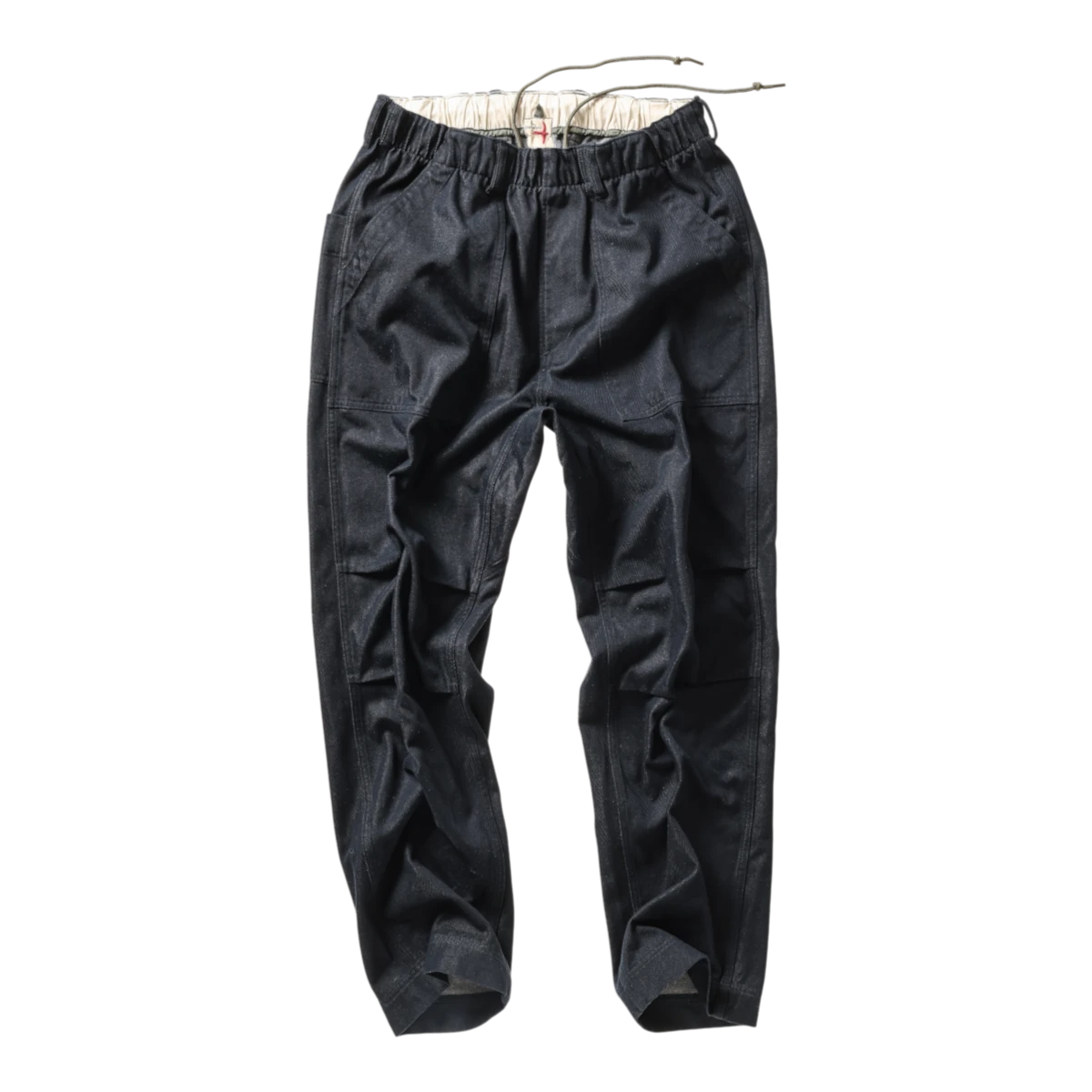 MILWORKS Relwen dark indigo utility pants with an elastic drawstring waist and durable cotton construction.