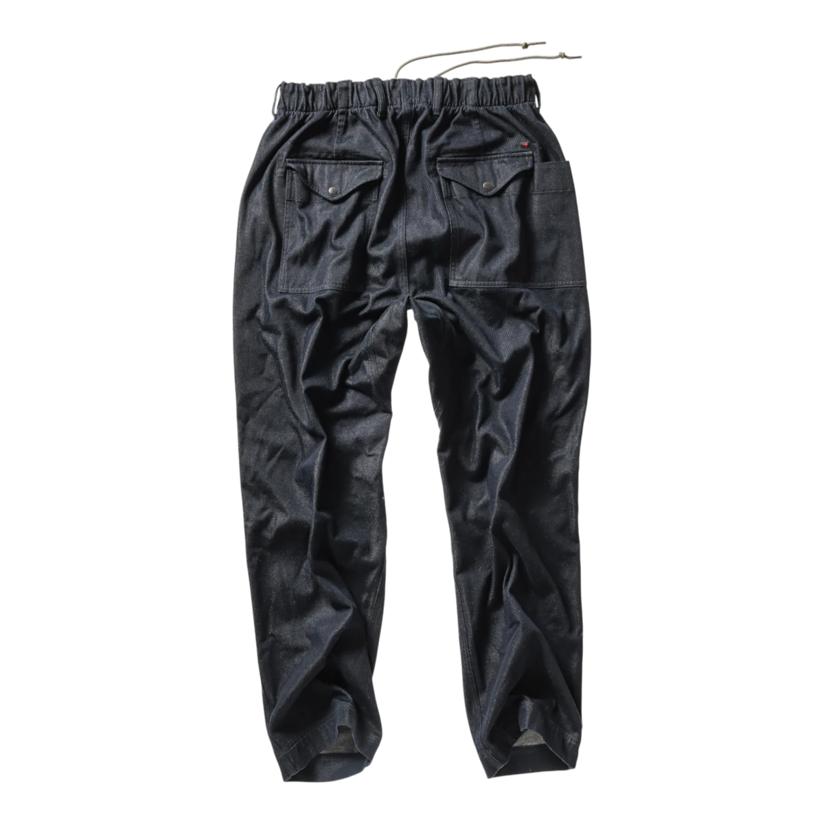 MILWORKS Relwen dark indigo utility pants with an elastic drawstring waist and rear flap pockets, back view.