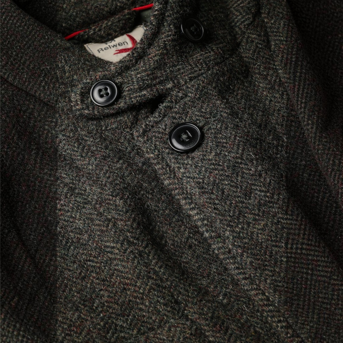 MILWORKS Relwen Heritage Trap Blazer in charcoal and olive herringbone wool with black buttons and collar detail