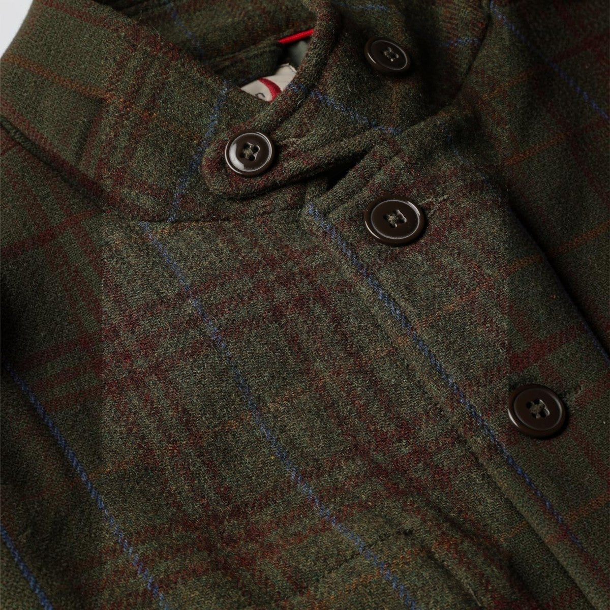 MILWORKS Relwen Heritage Trap Blazer in loden green and rust plaid wool with a button-up collar and front closure.
