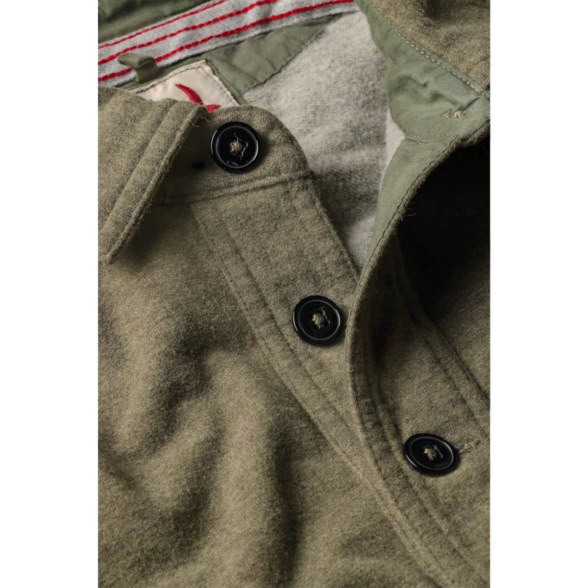 MILWORKS Relwen Mariner Polo in bright loden green featuring a buttoned placket and contrast interior trim detail.