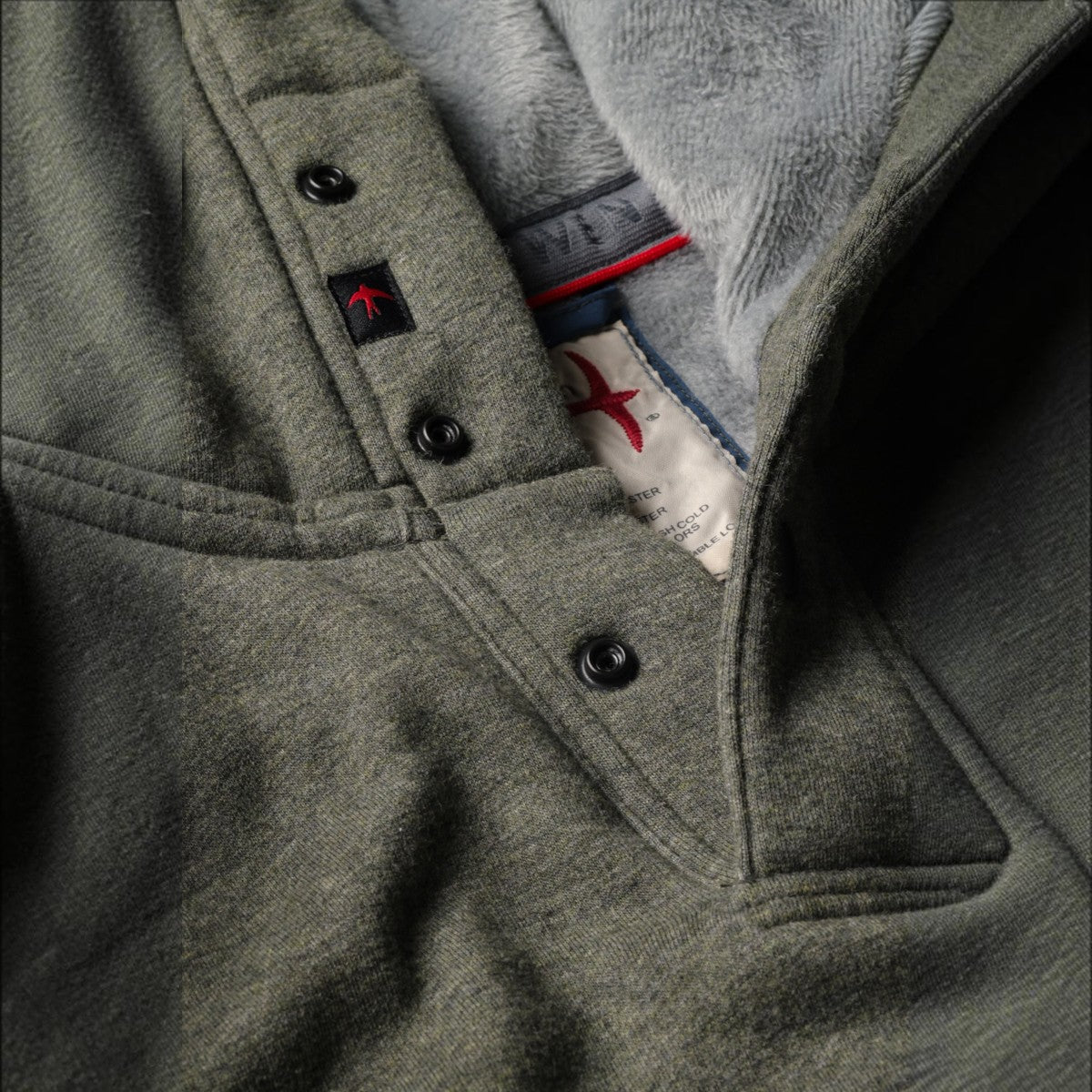 MILWORKS Relwen Micropile Hoodie in smoke olive featuring a snap button placket and soft grey fleece interior lining.