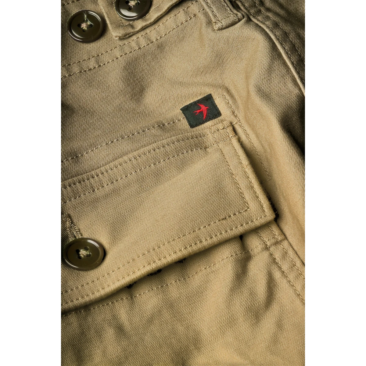 MILWORKS Relwen Supply worker pant in khaki featuring a small bird logo patch on the pocket and button details