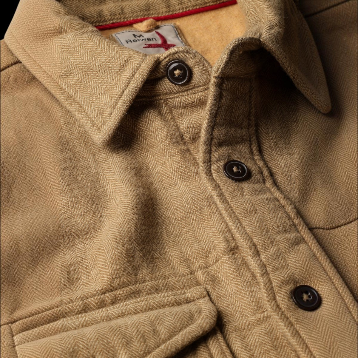 MILWORKS Relwen utility workshirt in cornmeal herringbone fabric with dark buttons and red interior collar detail