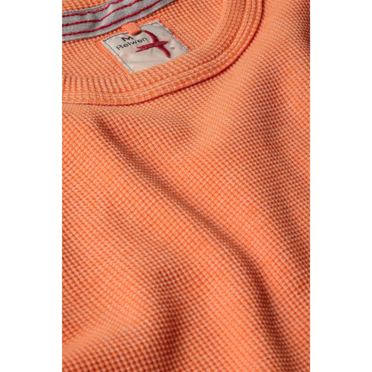MILWORKS Relwen Bi Waffle Crew sweater in citrus orange featuring a textured waffle knit fabric and interior label.