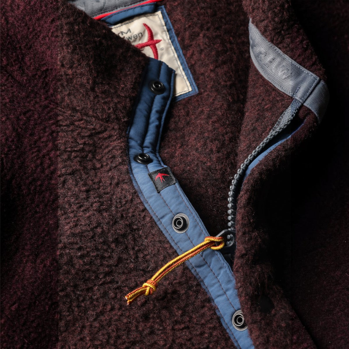 MILWORKS Relwen Wooly Shag Snap Zip jacket in blackberry with blue trim, snap buttons, and a zipper closure.