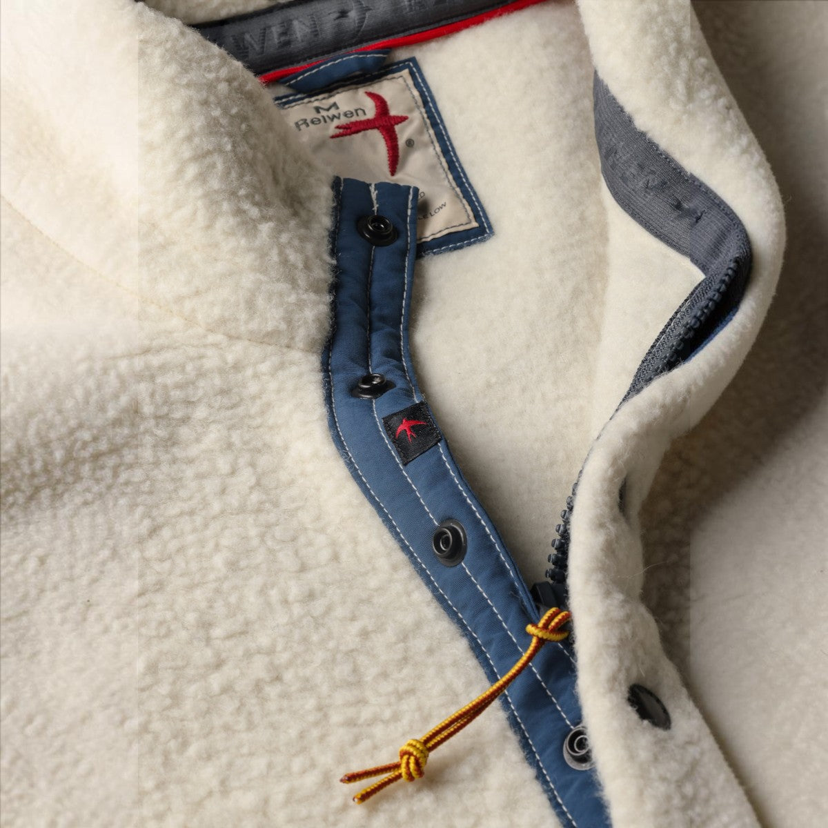 MILWORKS Relwen Wooly Shag snap zip fleece in white with blue trim and detailed collar stitching