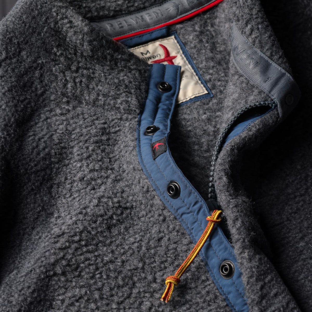 MILWORKS Relwen Wooly Shag snap-up fleece in light charcoal with blue trim and contrast zipper pull detail