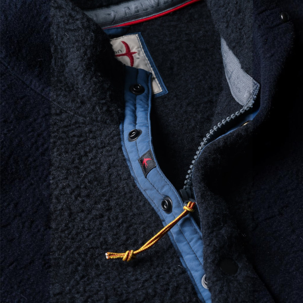 MILWORKS Relwen Wooly Shag Snap fleece in midnight blue with a zip and snap button placket detail.