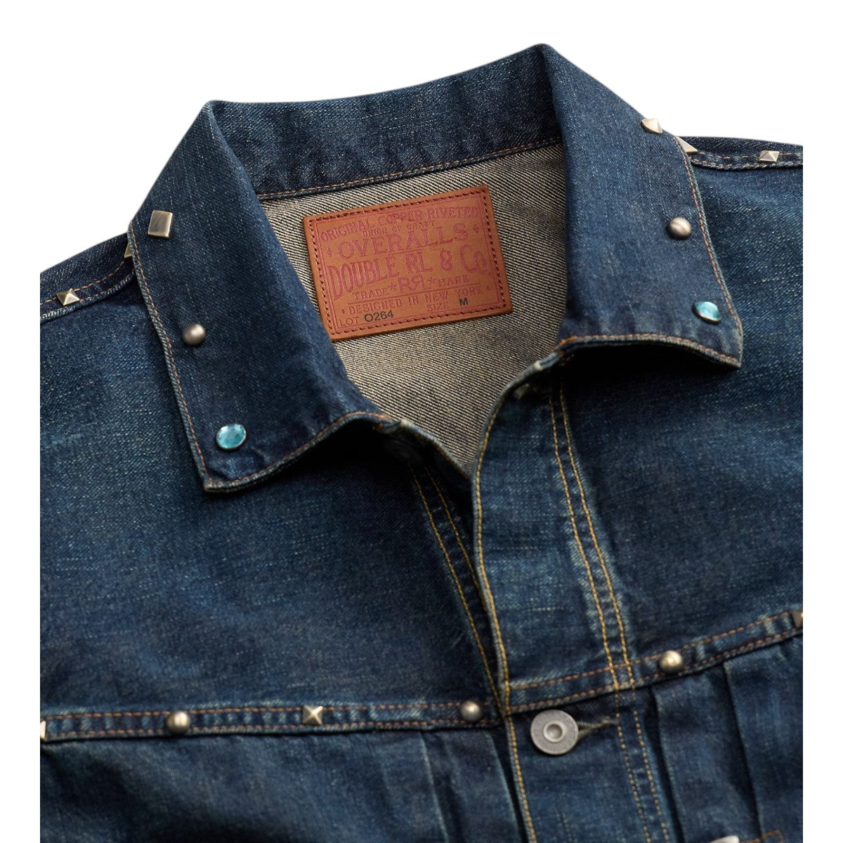 MILWORKS Ridgewood studded indigo denim trucker jacket featuring a leather interior logo patch and metal rivets