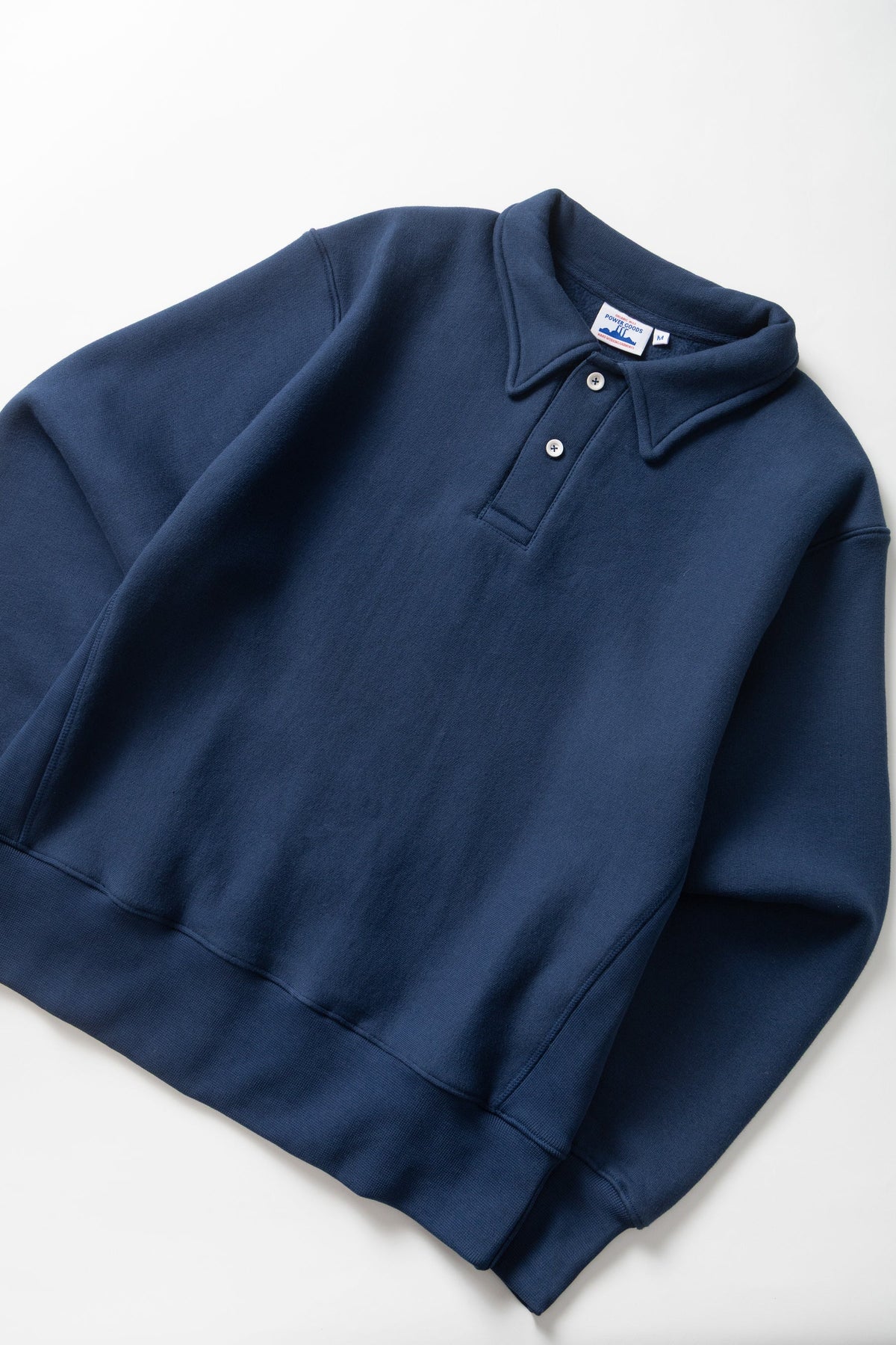 MILWORKS royal blue heavyweight organic cotton rugby shirt with a two-button collar and ribbed cuffs.