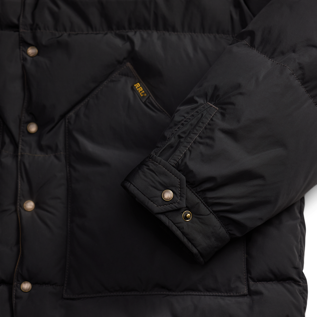 MILWORKS RRL black nylon coat featuring cowhide trim, snap button closure, and a branded pocket label