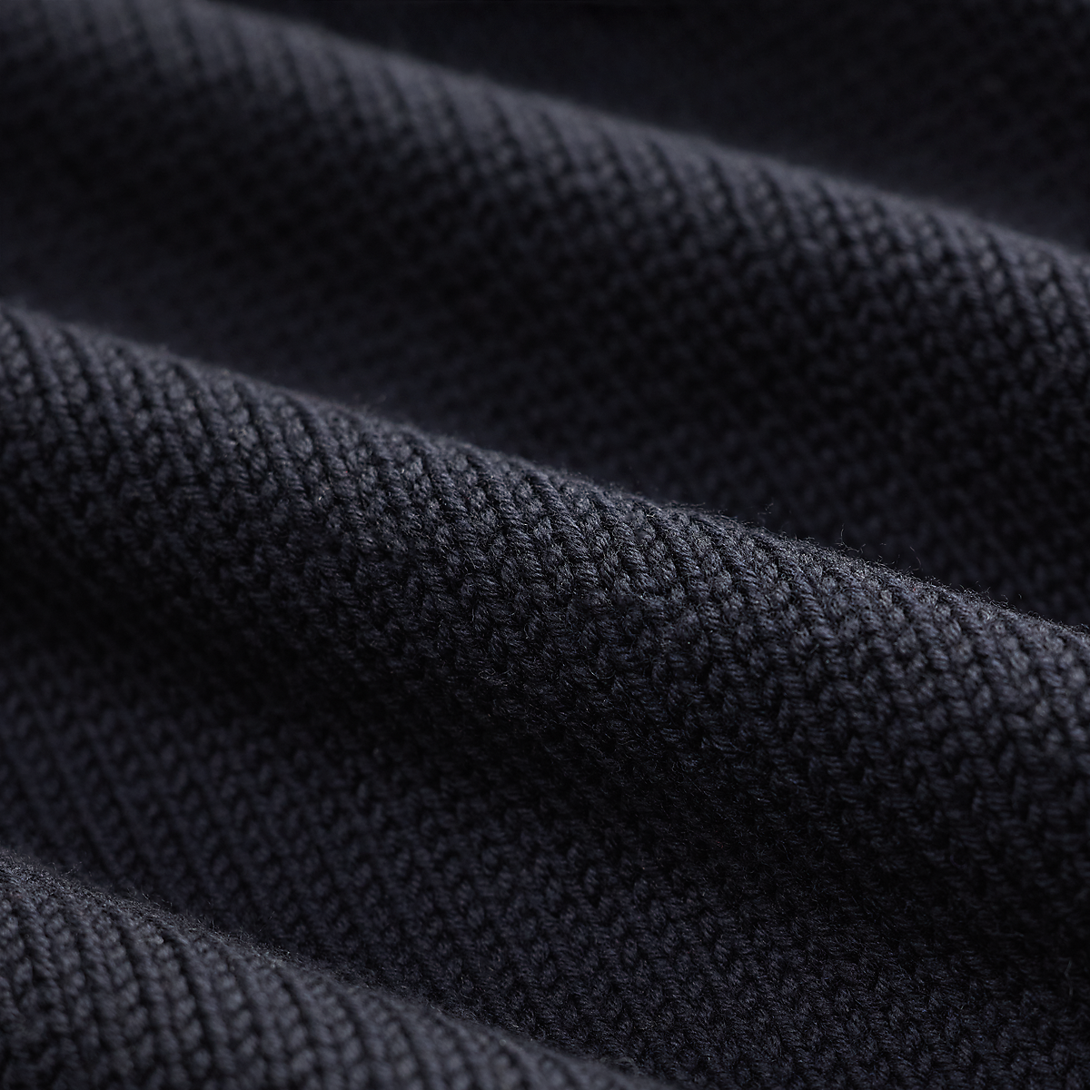 Close-up of the dark navy knit texture of a RRL long sleeve pullover sweater from MILWORKS
