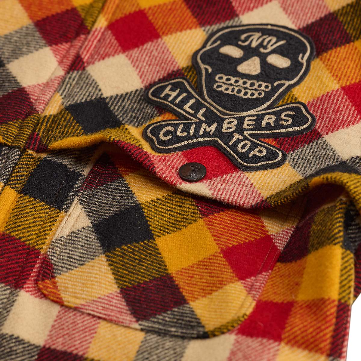 MILWORKS RRL wool woven shirt in yellow and red plaid with a skull and crossbones embroidered patch on the pocket