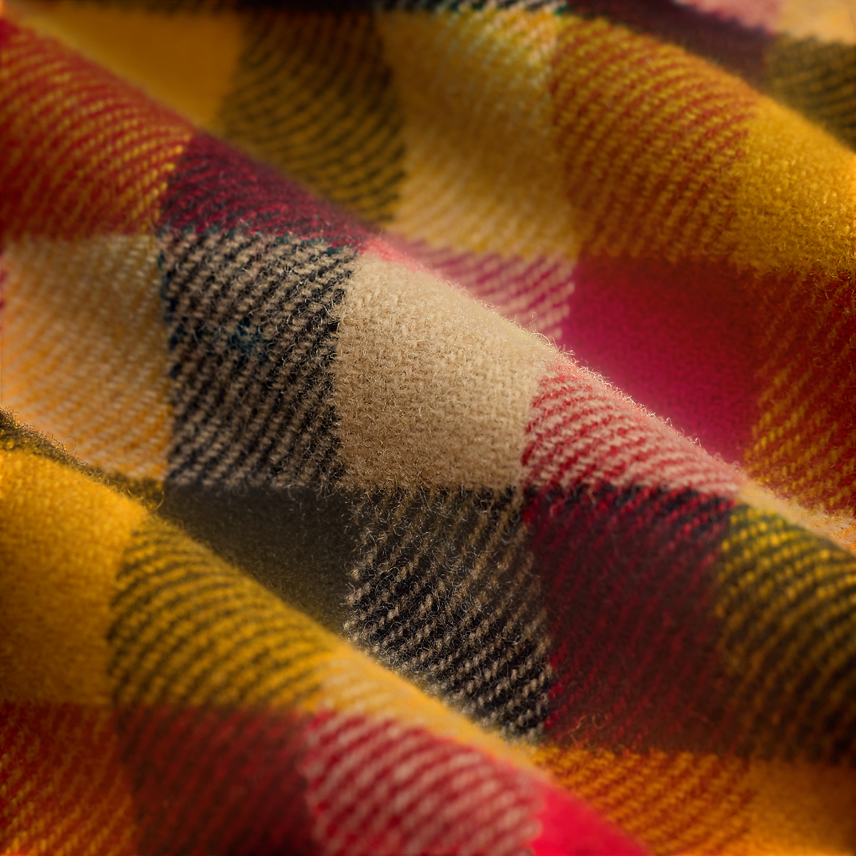 Close-up of a MILWORKS RRL wool woven shirt featuring a vibrant yellow, red, and black plaid check pattern.