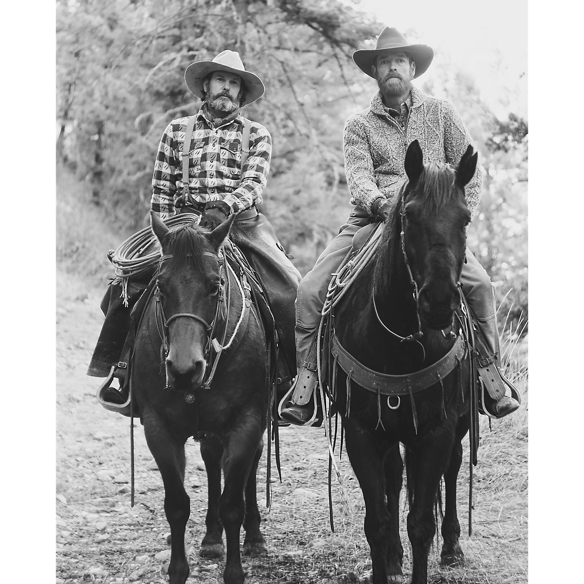 Two men in cowboy hats riding horses, one wearing a MILWORKS RRL brown and cream patterned wool long sleeve shirt.