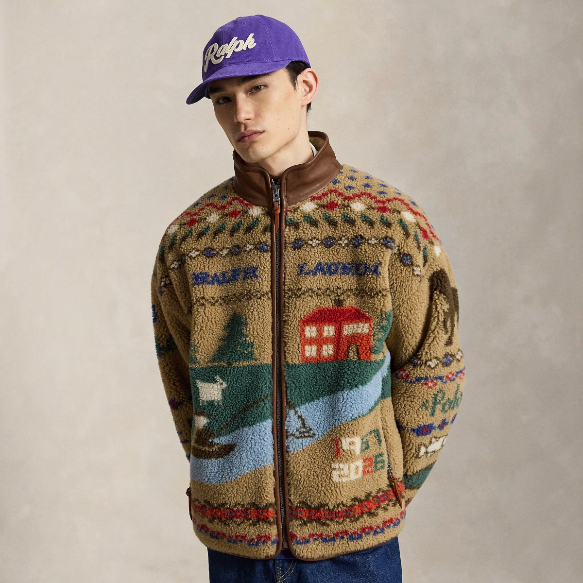 MILWORKS model wearing a khaki scenic pile fleece jacket with geometric motifs, leather trim, and full-zip front.
