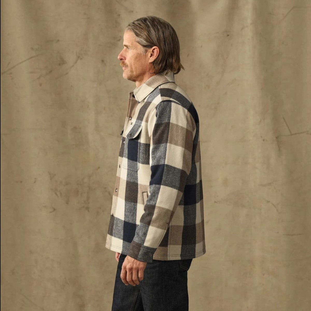 MILWORKS Spokane insulated jac-shirt in cream and navy plaid wool-blend, worn by a man in profile view.