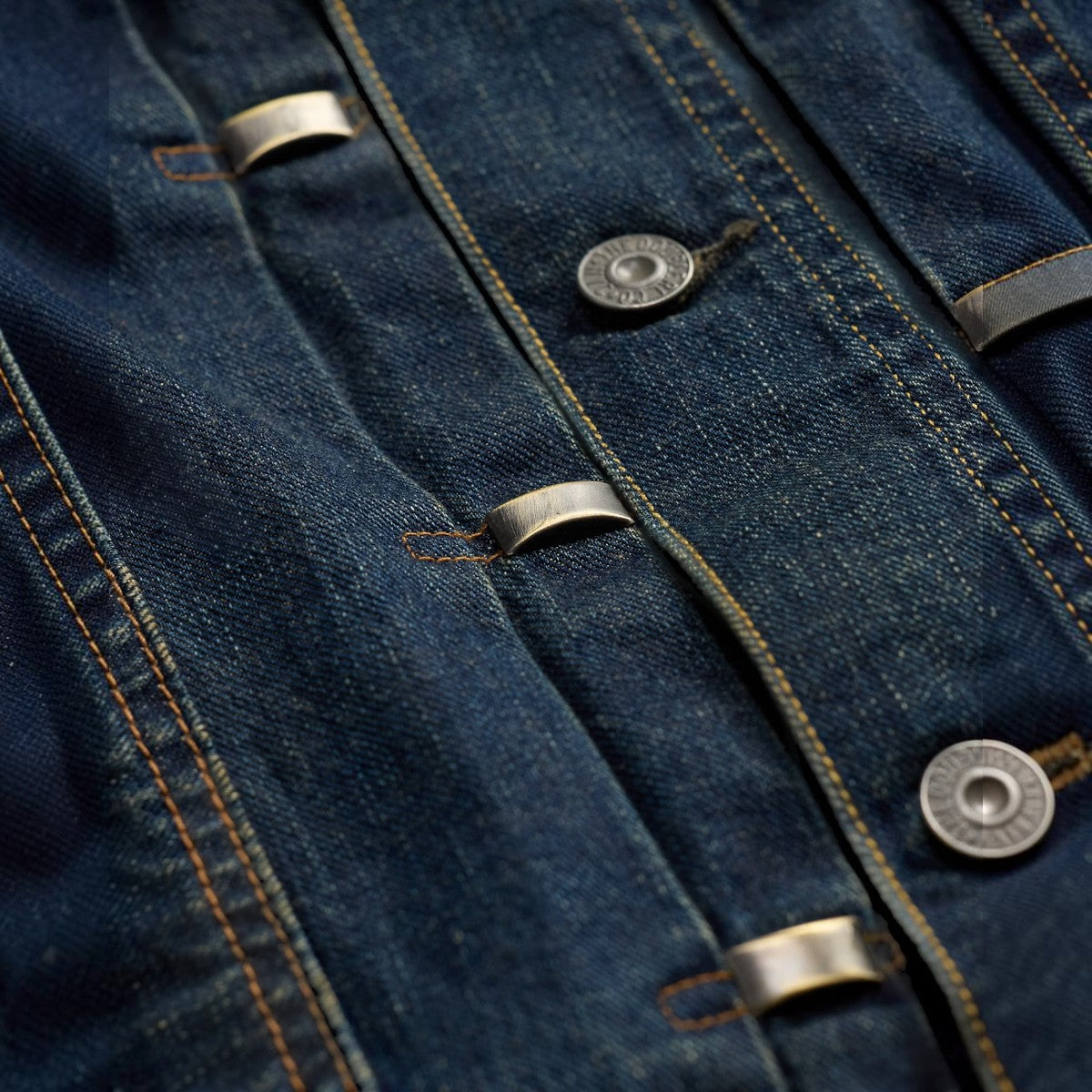 MILWORKS Ridgewood studded indigo Japanese denim trucker jacket featuring metal buttons and decorative studs