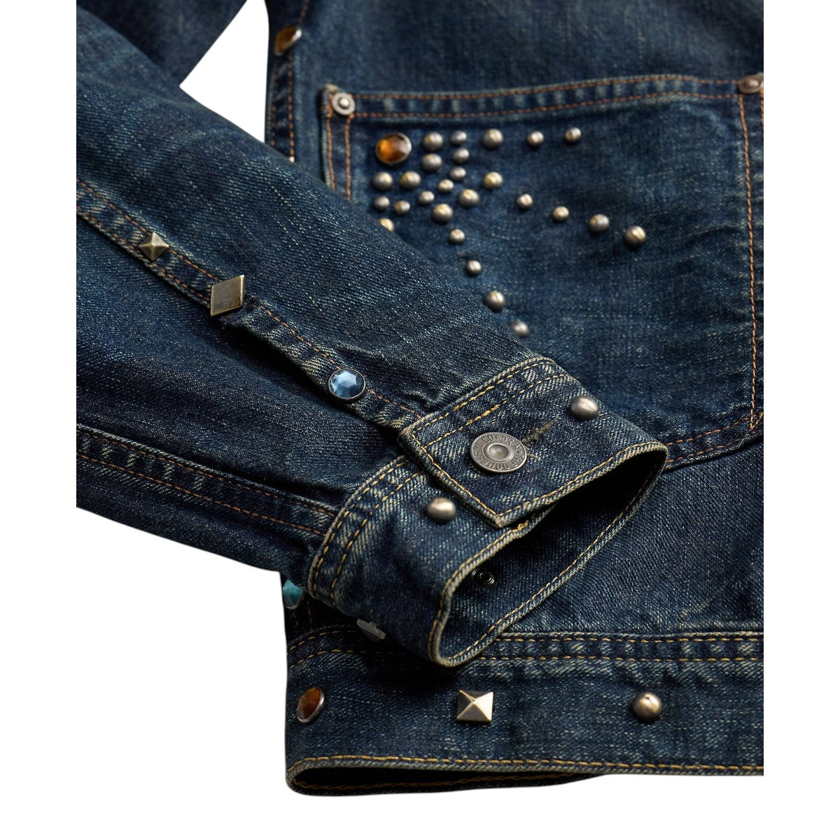 MILWORKS Ridgewood studded indigo denim trucker jacket sleeve detail with metal rivets and decorative studs